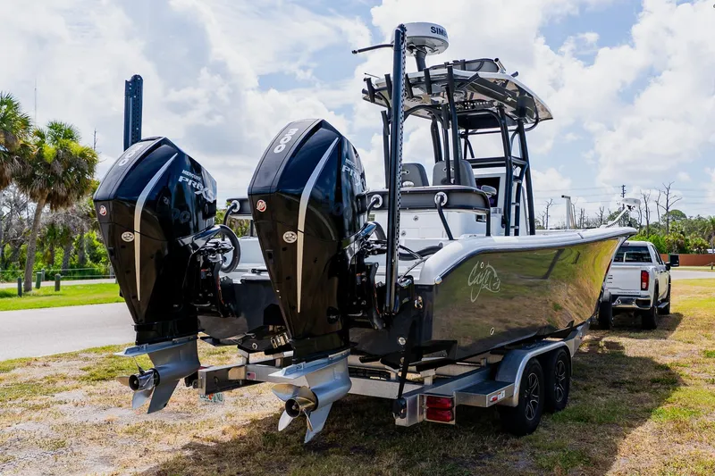 Slide: The Image of 2021 Costa Custom Boats 264HC with dual Mercury engines on a trailer. - 11