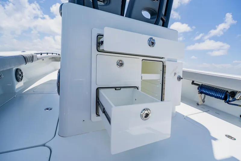 Slide: The Image of 2021 Costa Custom Boats 264HC interior storage compartments under a clear blue sky. - 59