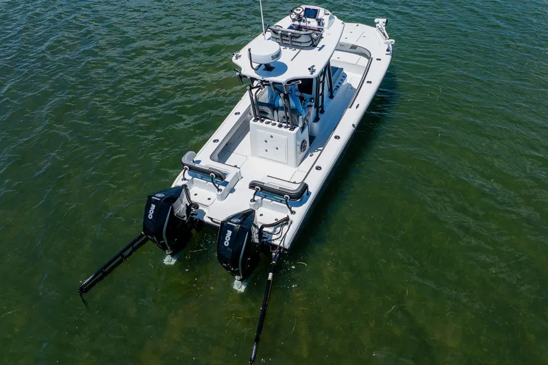 Slide: The Image of 2021 Costa Custom Boats 264HC on water, featuring dual outboard motors. - 16