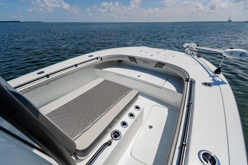 Slide: The Image of 2021 Costa Custom Boats 264HC on calm water, featuring spacious seating and sleek design. - 27