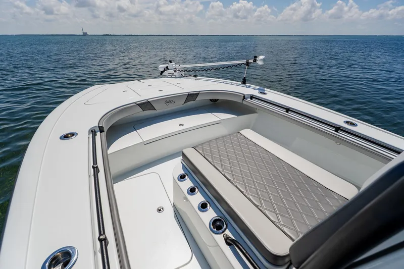Slide: The Image of 2021 Costa Custom Boats 264HC on calm water, featuring spacious seating and sleek design. - 28