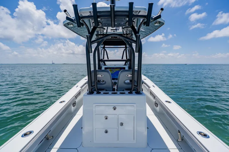 Slide: The Image of 2021 Costa Custom Boats 264HC on open water under a clear blue sky. - 58
