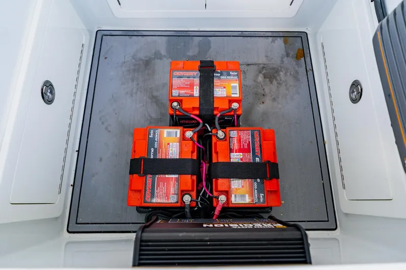 Slide: The Image of Batteries in a 2021 Costa Custom Boats 264HC compartment, secured with straps. - 50