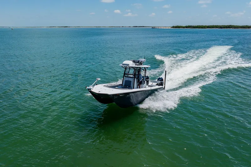 Slide: The Image of 2021 Costa Custom Boats 264HC cruising on clear blue water under a sunny sky. - 19