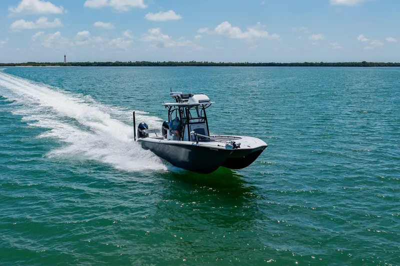 Slide: The Image of 2021 Costa Custom Boats 264HC cruising on open water under a clear sky. - 20