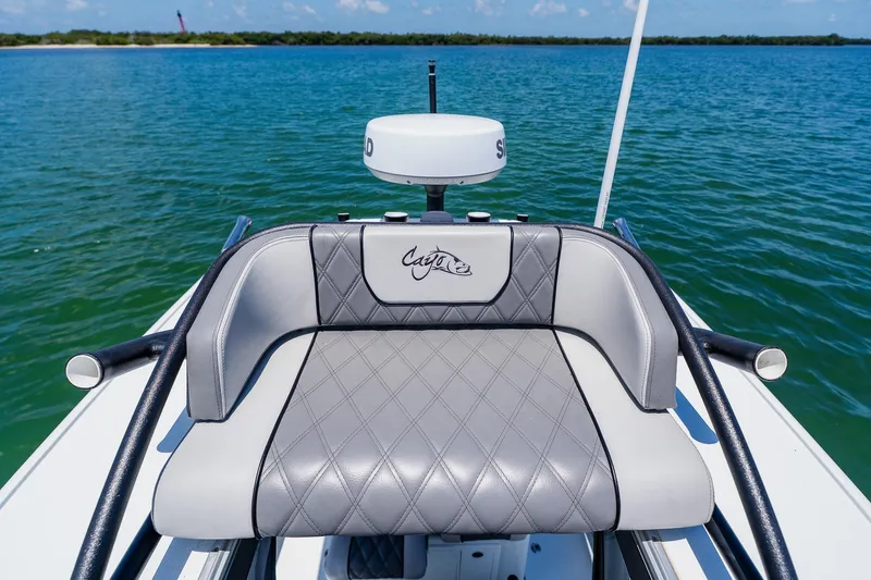 Slide: The Image of 2021 Costa Custom Boats 264HC seat with diamond stitching, overlooking serene blue waters. - 78