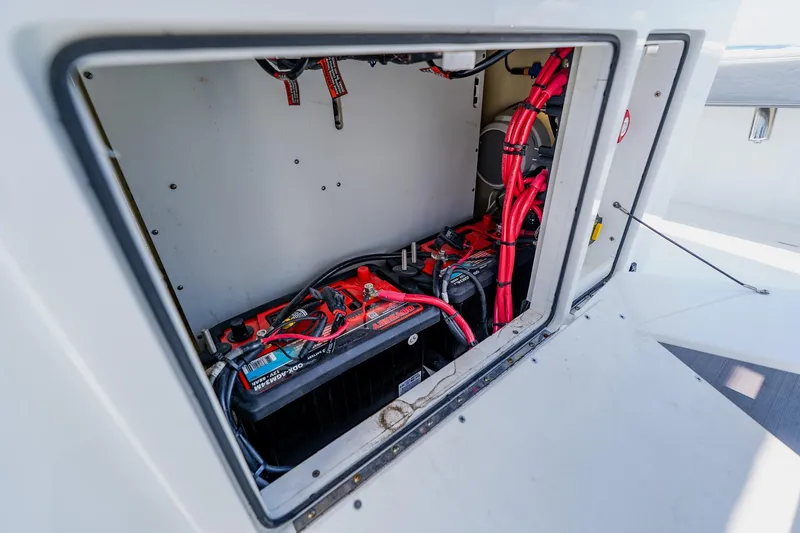 Slide: The Image of Battery compartment of 2021 Costa Custom Boats 264HC with visible wiring and connections. - 69