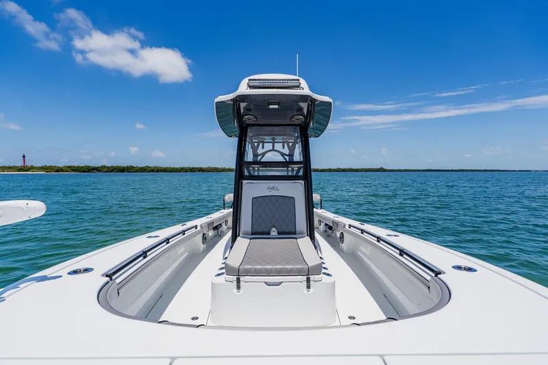 Slide: The Image of 2021 Costa Custom Boats 264HC on open water, clear sky, and scenic shoreline. - 45