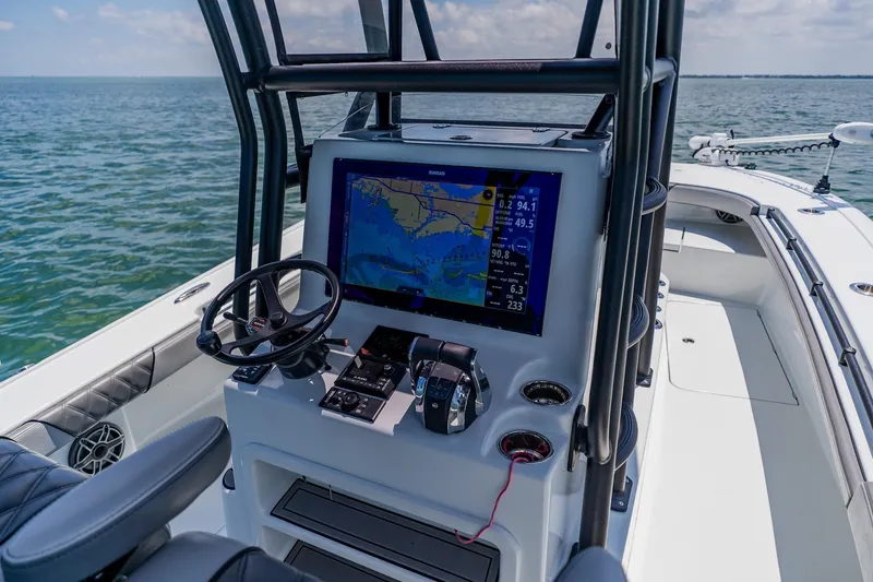 Slide: The Image of 2021 Costa Custom Boats 264HC helm with navigation display on open water. - 62