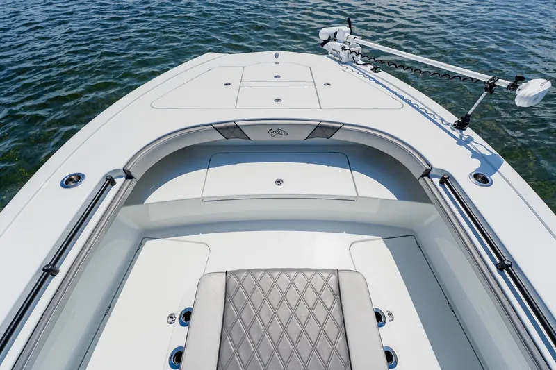 Slide: The Image of 2021 Costa Custom Boats 264HC bow with seating and trolling motor on calm water. - 29