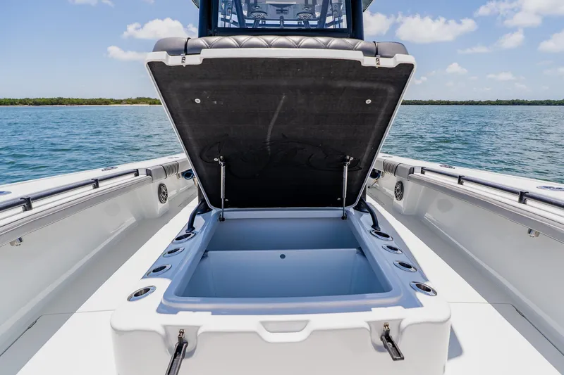 Slide: The Image of Open storage compartment on 2021 Costa Custom Boats 264HC, with ocean backdrop. - 55
