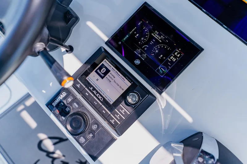 Slide: The Image of Control panel of 2021 Costa Custom Boats 264HC with Simrad and JL Audio systems. - 73