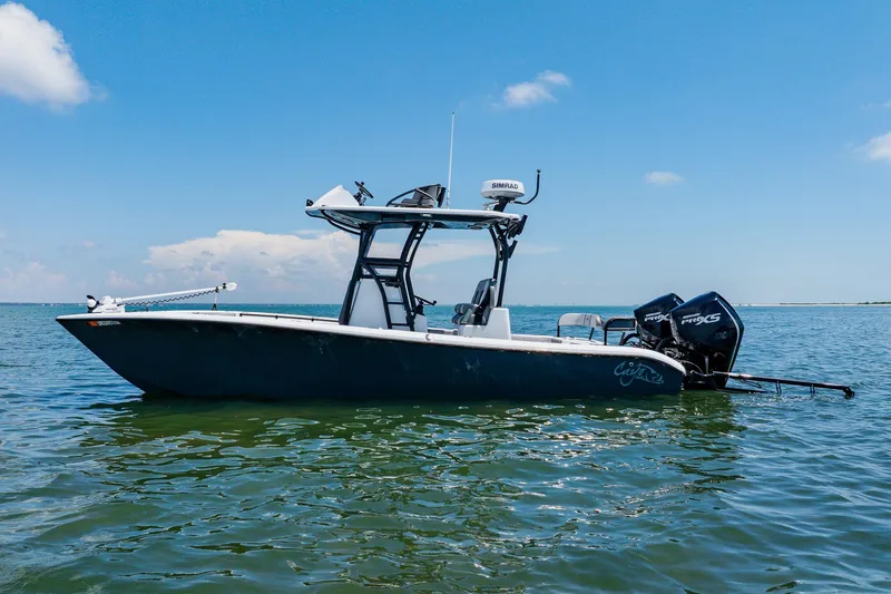 The Image of 2021 Costa Custom Boats 264HC on calm water under clear blue sky. - 12