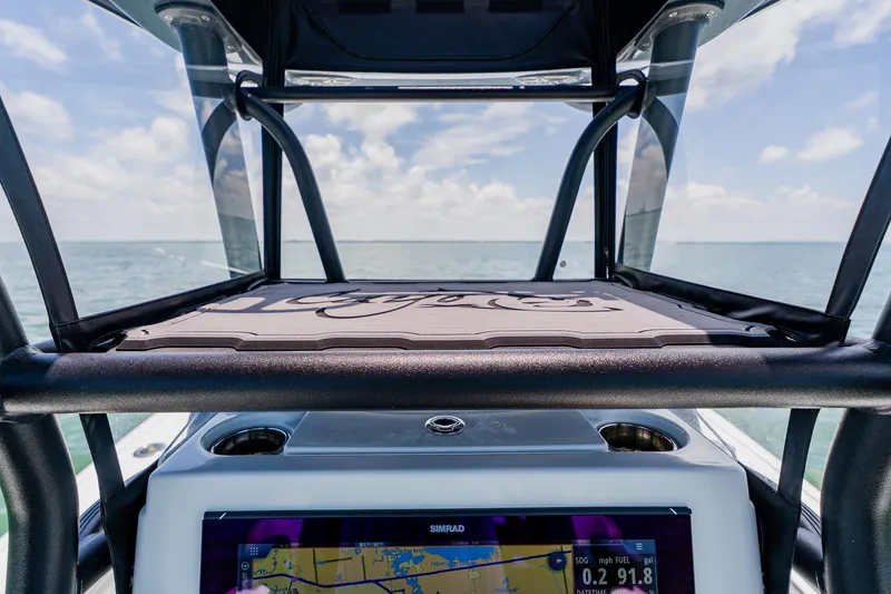 Slide: The Image of 2021 Costa Custom Boats 264HC dashboard with navigation screen, ocean view in background. - 75