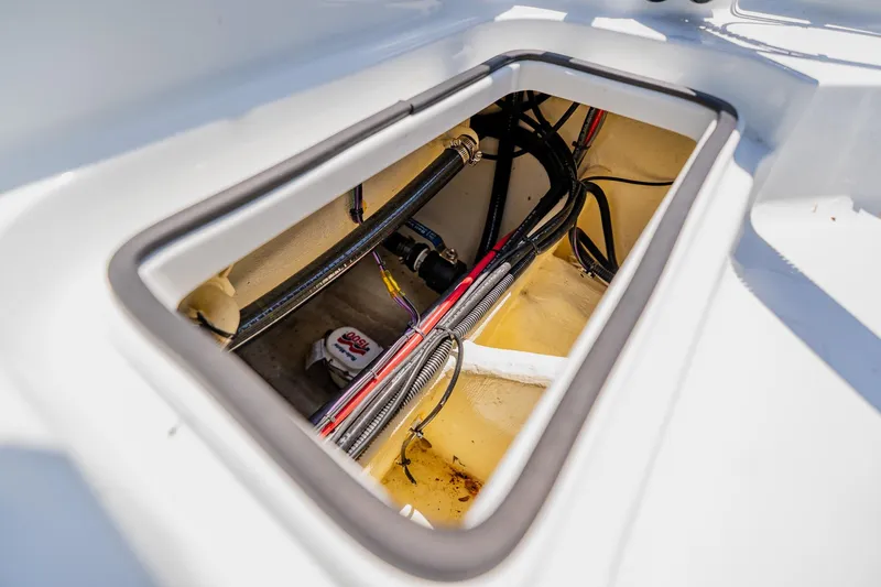 Slide: The Image of Open hatch of 2021 Costa Custom Boats 264HC showing internal wiring and components. - 97