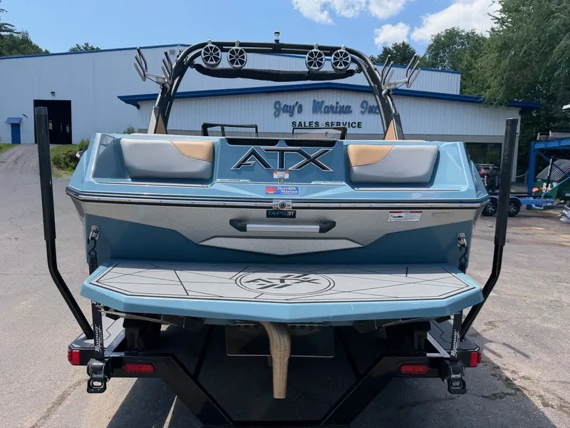 Slide: The Image of Rear view of a blue 2021 ATX 22 Type-S boat parked in front of a building. - 15