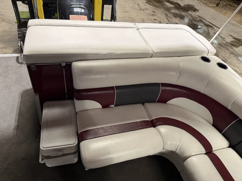 Slide: The Image of Interior of a 2011 JC Spirit with cushioned seating in white, red, and gray. - 4