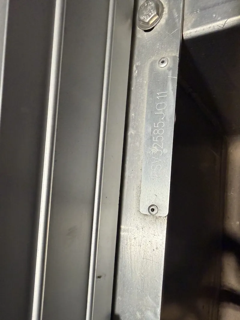 Slide: The Image of Close-up of a metal part with engraving and screws. - 18