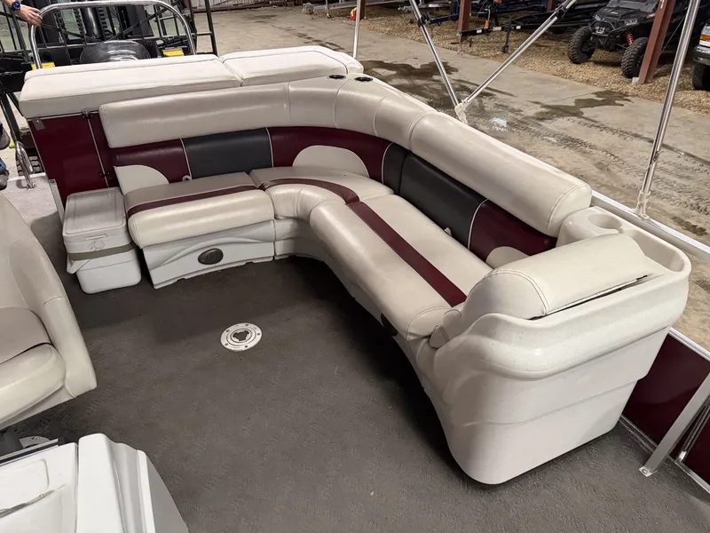 Slide: The Image of Interior of a 2011 JC Spirit with cushioned seating in beige and red. - 17