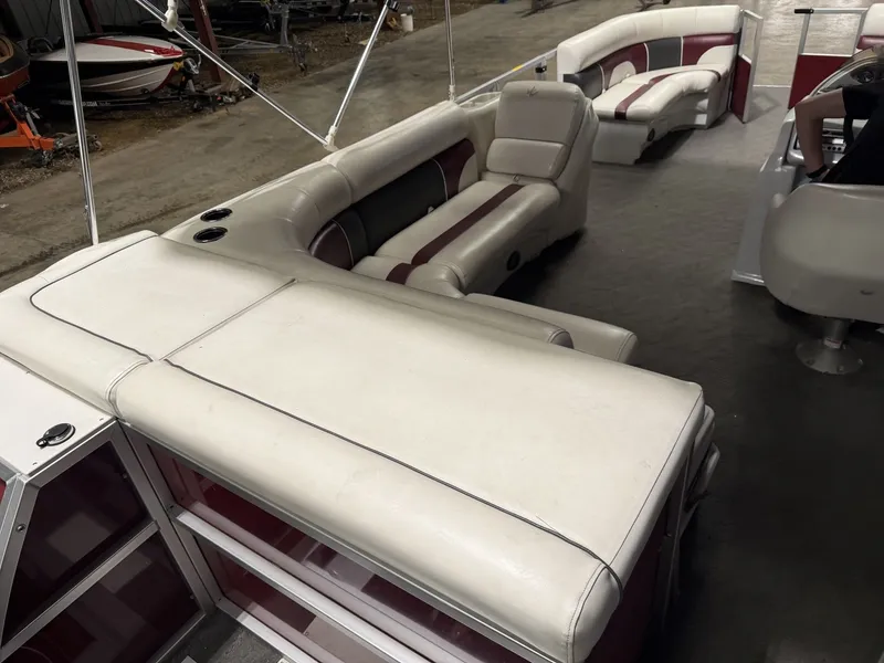 Slide: The Image of Interior of a JC Spirit pontoon boat with white and red seating. - 20