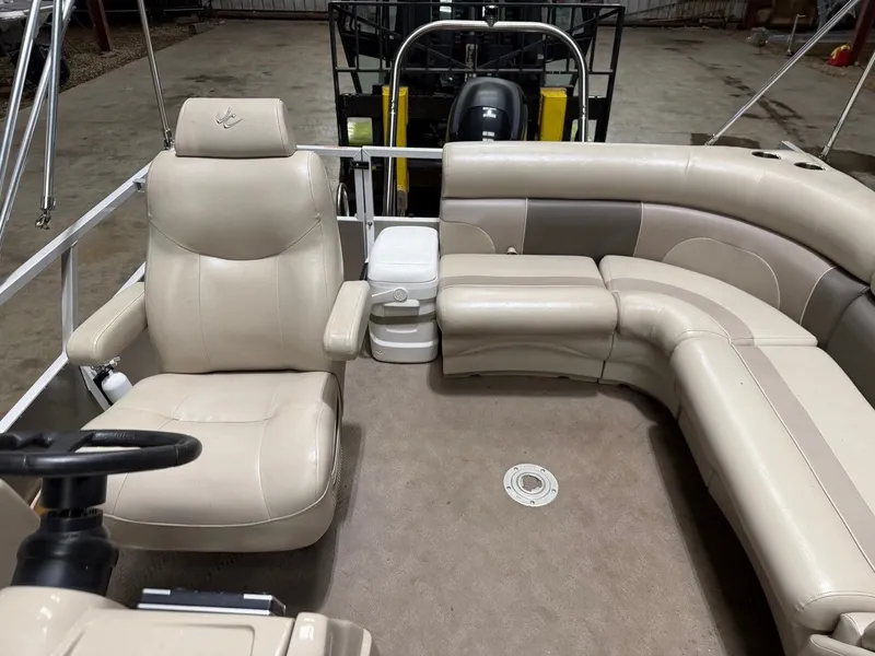 Slide: The Image of Interior of a pontoon boat with beige leather seating and steering wheel. - 14