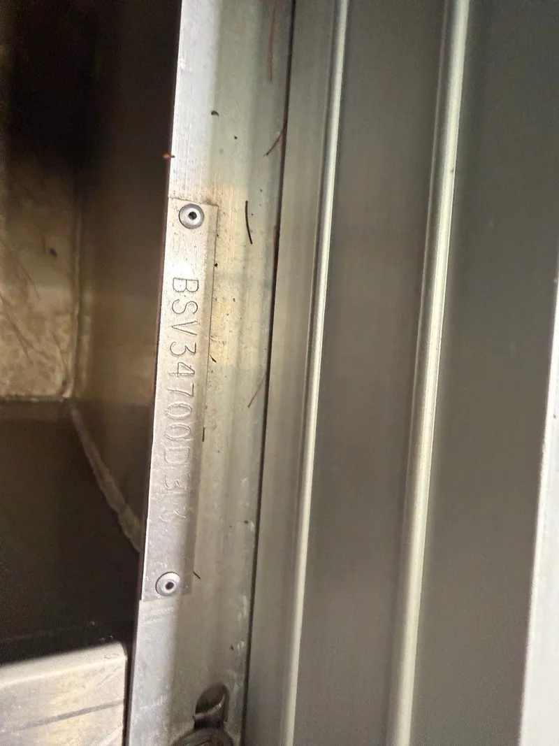 Slide: The Image of Close-up of a metal frame with an engraved serial number. - 19