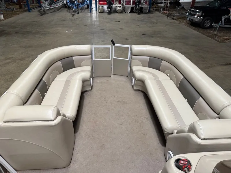 Slide: The Image of Interior view of a pontoon boat with beige seating and carpeted floor. - 4