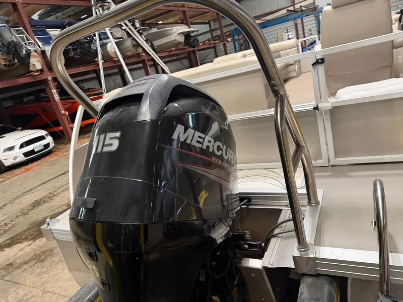 Slide: The Image of A Mercury 115 outboard motor on a pontoon boat in a warehouse. - 11