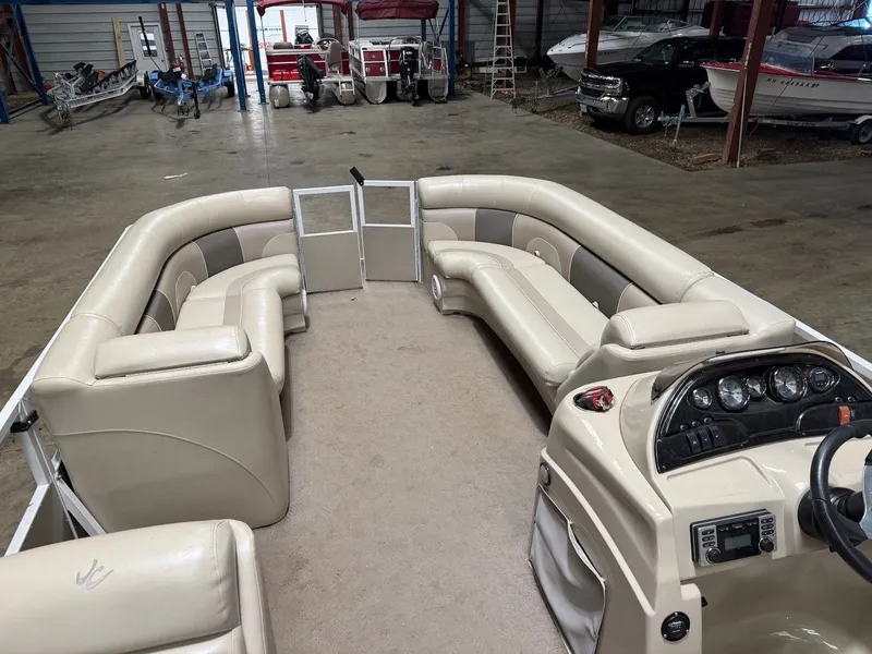 Slide: The Image of Interior view of a pontoon boat with beige seating and a helm station. - 3