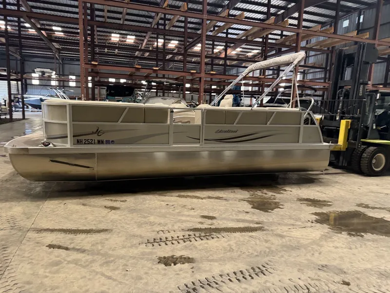 Slide: The Image of A pontoon boat is in a warehouse on a concrete floor. - 5
