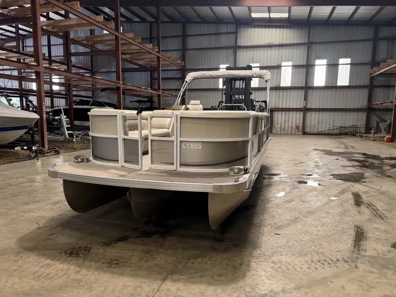 Slide: The Image of A pontoon boat is in a warehouse on a concrete floor. - 24