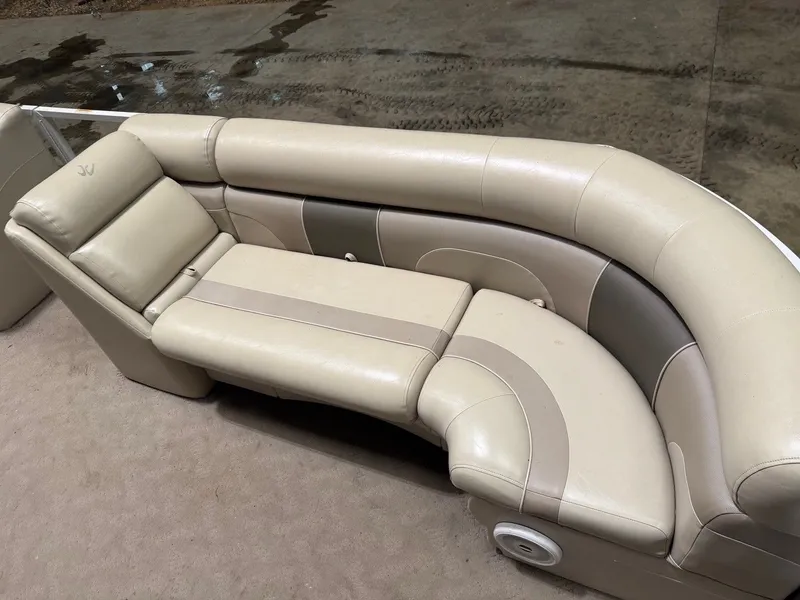 Slide: The Image of Beige upholstered seating on a boat with a curved design. - 20