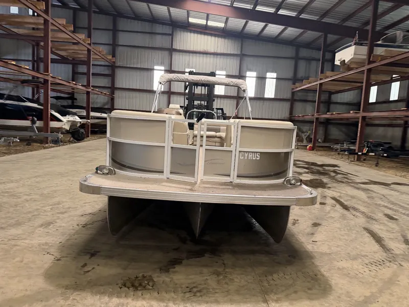 Slide: The Image of A pontoon boat is parked in a warehouse on a concrete floor. - 7