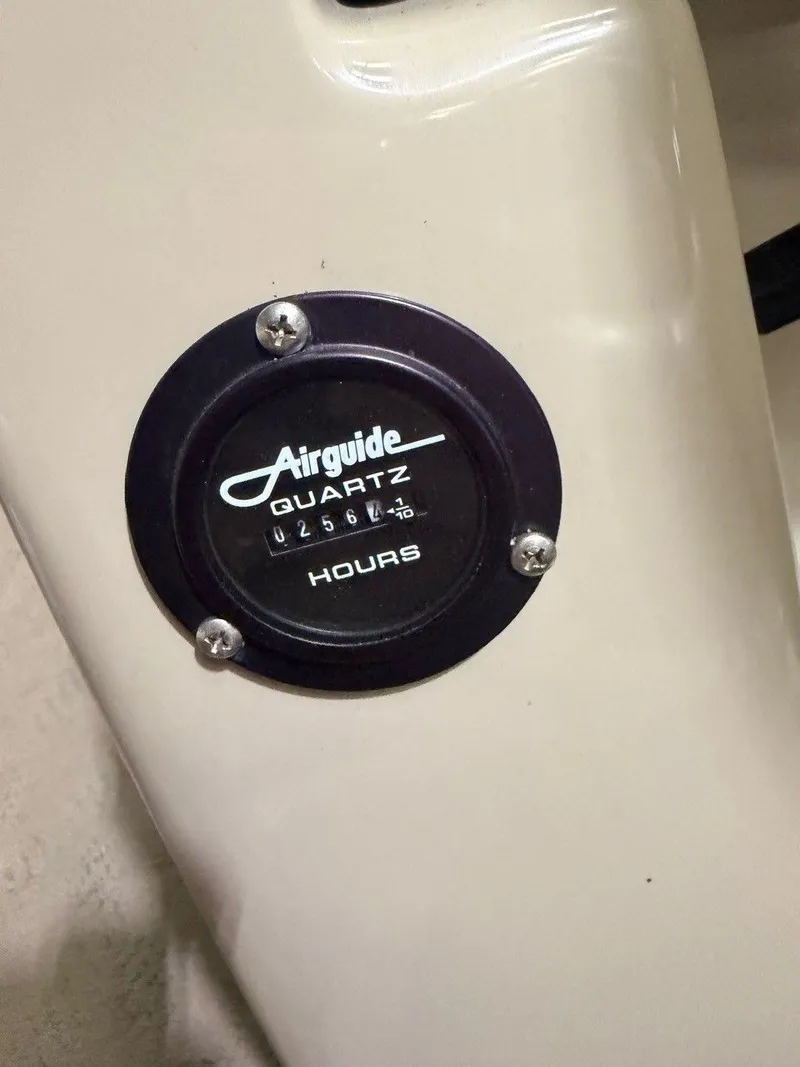 Slide: The Image of Close-up of an hour meter labeled "Airguide Quartz." - 13