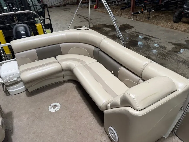 Slide: The Image of Interior of a pontoon boat with beige leather seating and carpeted floor. - 15