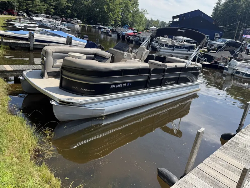 Slide: The Image of A 2014 Premier 240 SunSation pontoon boat docked in a calm harbor. - 4