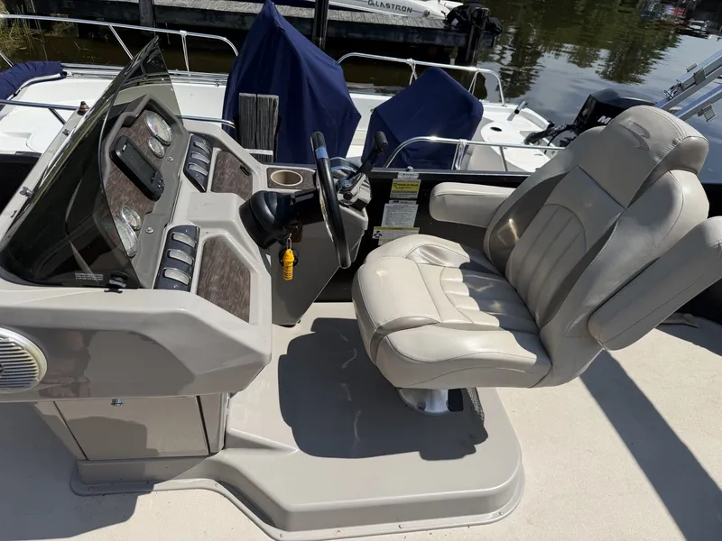 Slide: The Image of The image shows the helm of a 2014 Premier 240 SunSation boat with a comfortable seat. - 9