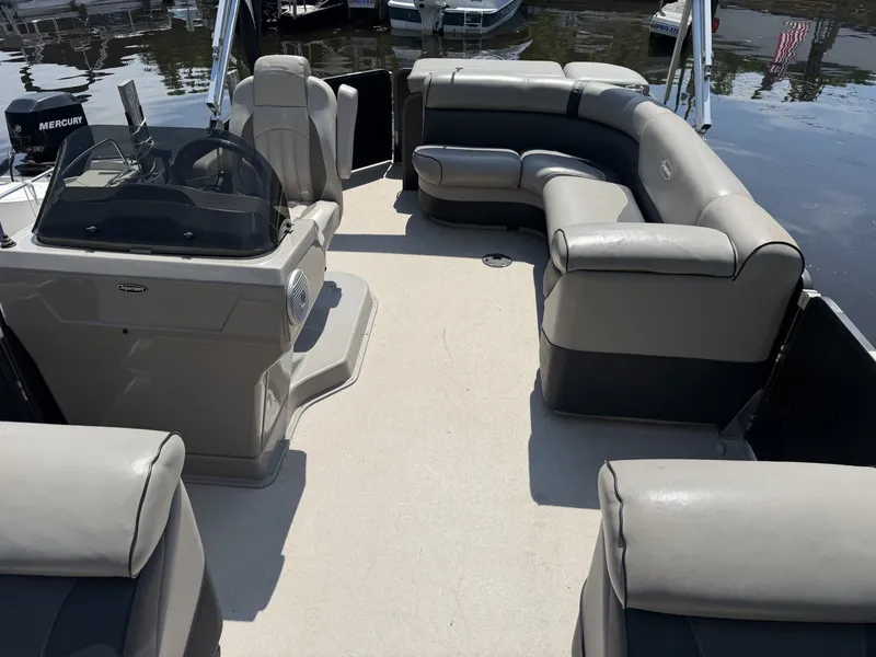 Slide: The Image of The image shows the spacious deck of a 2014 Premier 240 SunSation pontoon boat. - 6