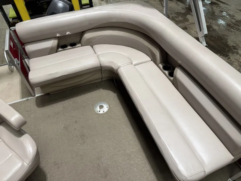 Slide: The Image of Interior view of a Starcraft boat with beige upholstered seating and carpeted floor. - 9
