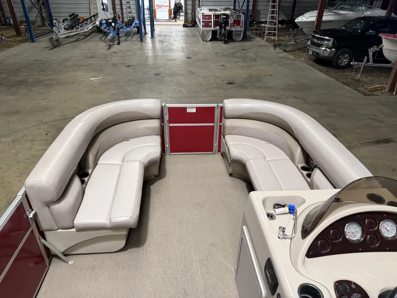 Slide: The Image of Interior view of a Starcraft boat with beige seating and red railing. - 19