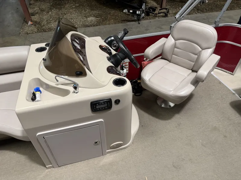 Slide: The Image of Interior view of a Starcraft boat with steering wheel and beige seat. - 11