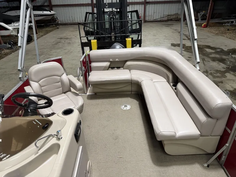 Slide: The Image of Interior view of a Starcraft boat with beige seating and steering wheel. - 3