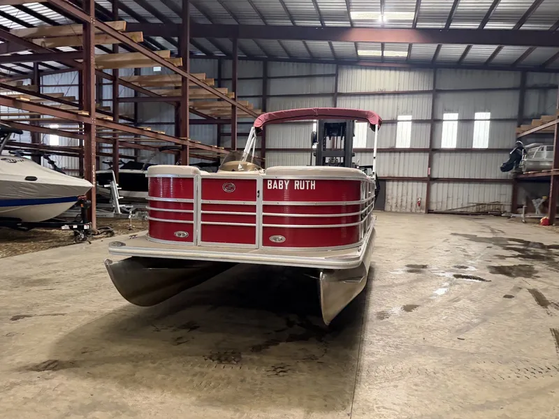 Slide: The Image of A red pontoon boat in a warehouse, with the name "Baby Ruth" on the front. - 16