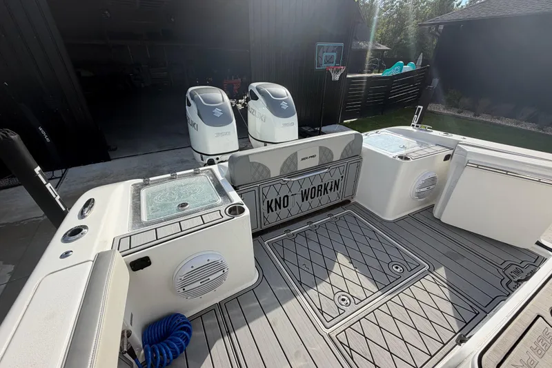 Slide: The Image of 2024 Sea Pro 322 Offshore boat interior with Suzuki engines, featuring spacious deck and storage. - 11