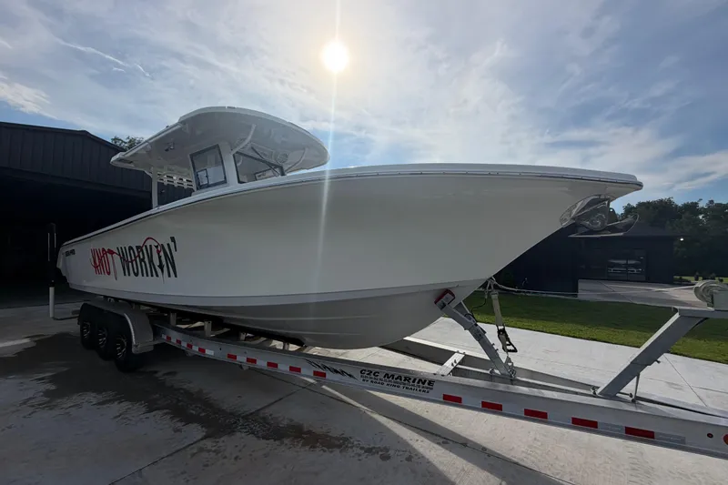 Slide: The Image of 2024 Sea Pro 322 Offshore boat on trailer under sunny sky. - 6