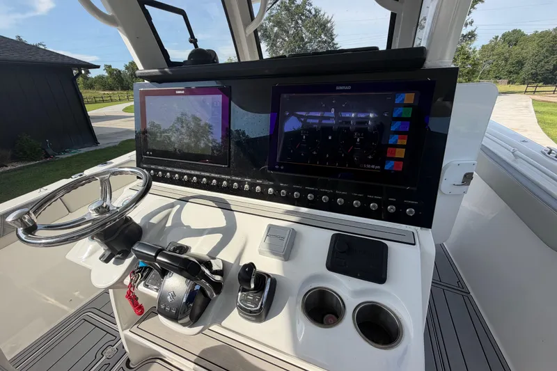 Slide: The Image of 2024 Sea Pro 322 Offshore boat helm with dual Simrad displays and modern controls. - 17