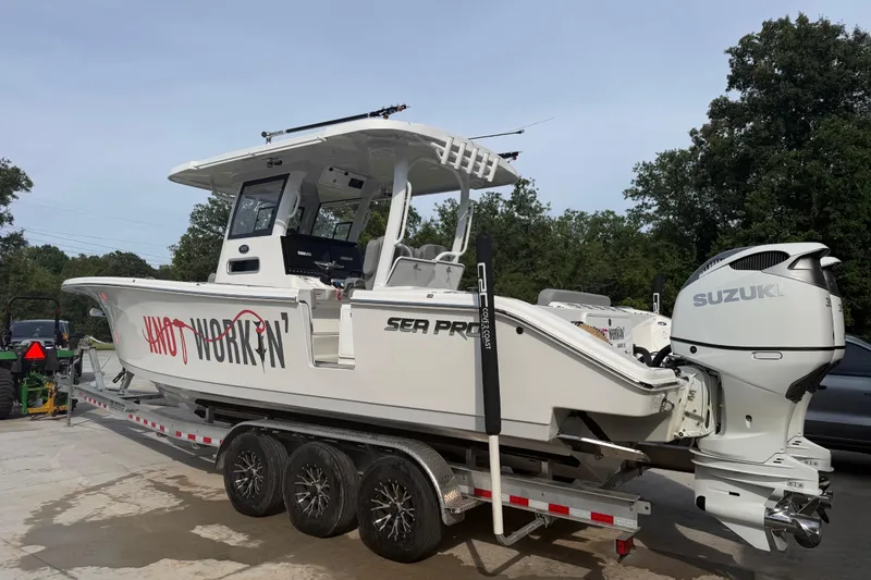 Slide: The Image of 2024 Sea Pro 322 Offshore boat on trailer with Suzuki outboard motor. - 7