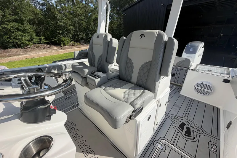 Slide: The Image of 2024 Sea Pro 322 Offshore boat interior with dual captain's chairs and steering wheel. - 16