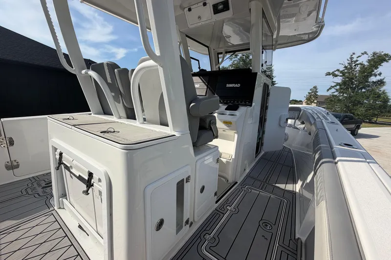 Slide: The Image of 2024 Sea Pro 322 Offshore boat interior with seating and navigation equipment. - 18
