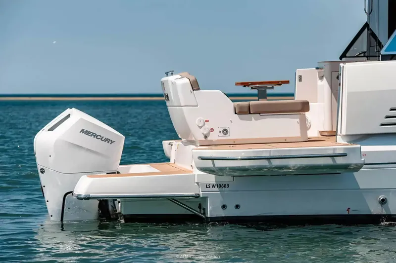 Slide: The Image of The stern of a Wellcraft 44 Explorer with a Mercury outboard motor on calm water. - 3